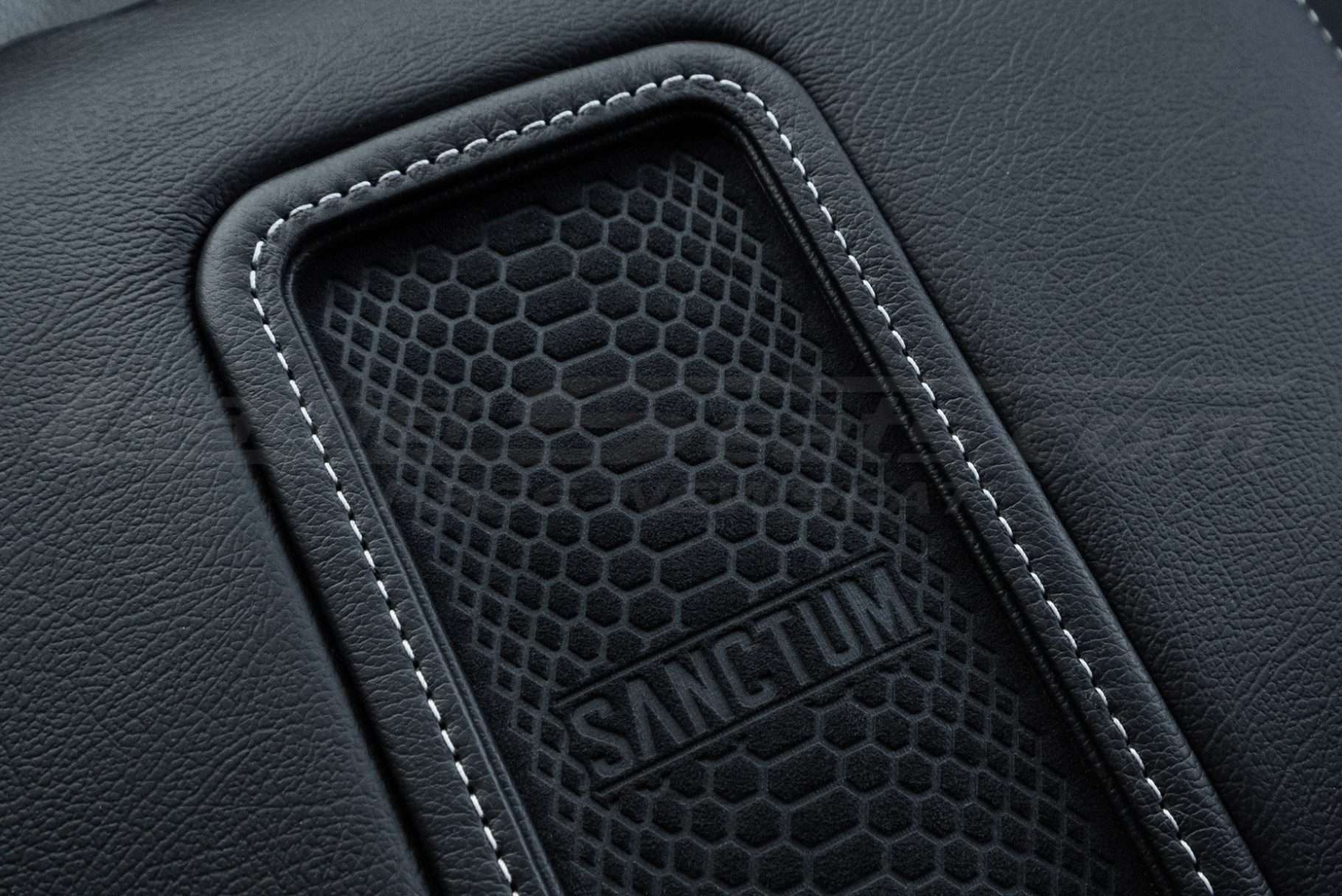 Silver stitching on charging pad close-up