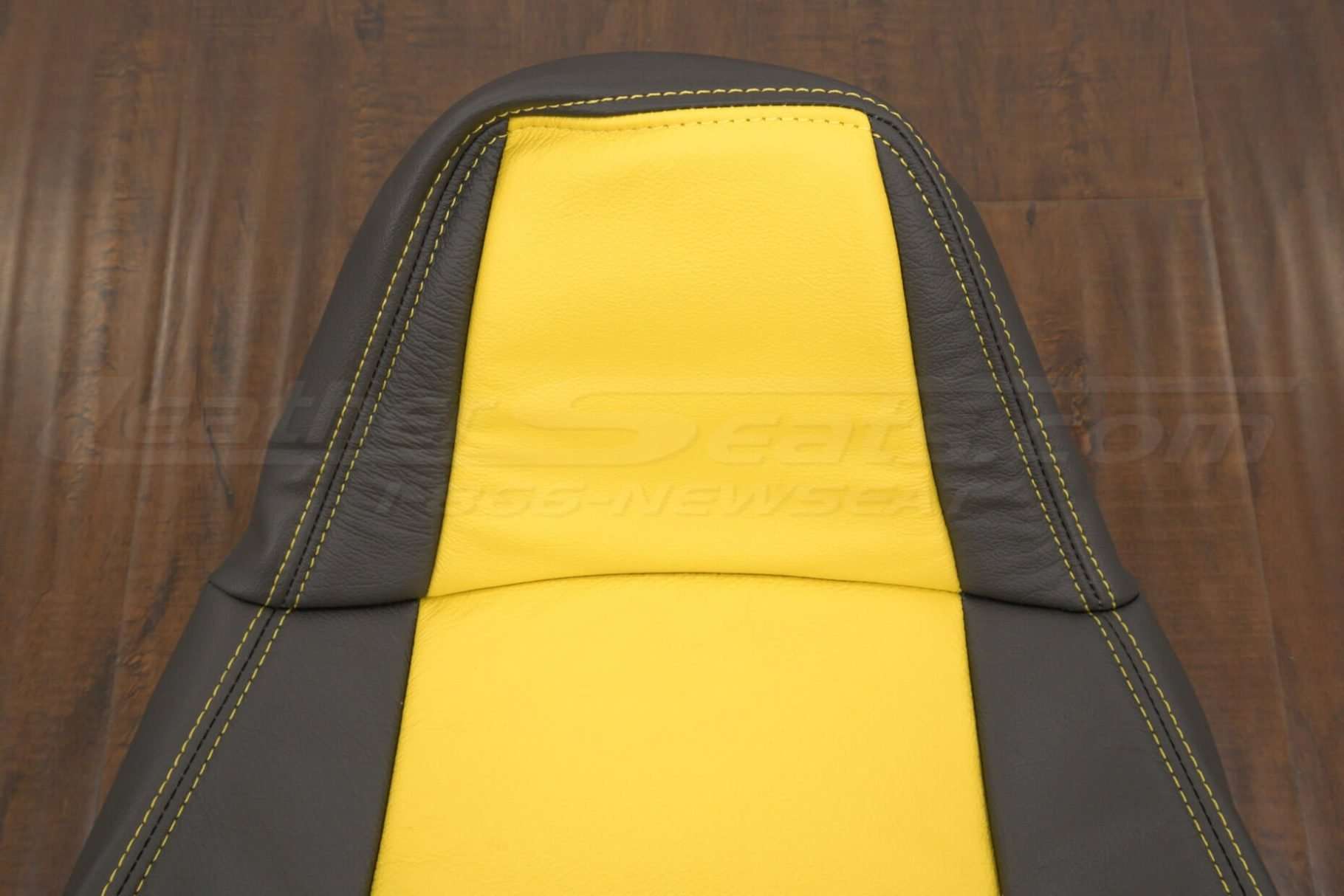 Upper section of front backrest with Velocity Yellow stitching