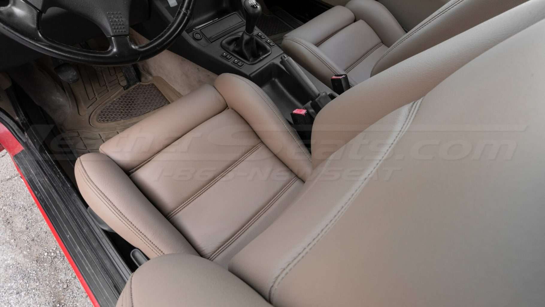 Top-down view of front driver installed leather seat - Nutmeg leather