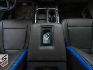 Top-down view of wireless charging console with phone being charged