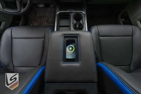 Top-down view of wireless charging console with phone being charged