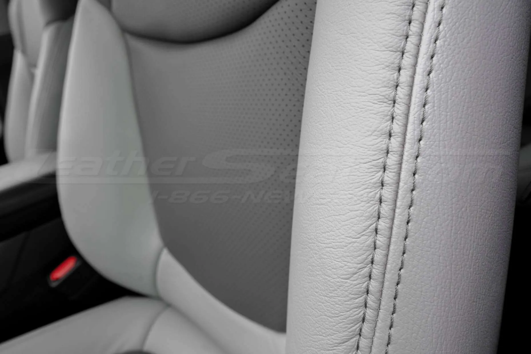 Contrasting Light Grey stitching on installed leather seat