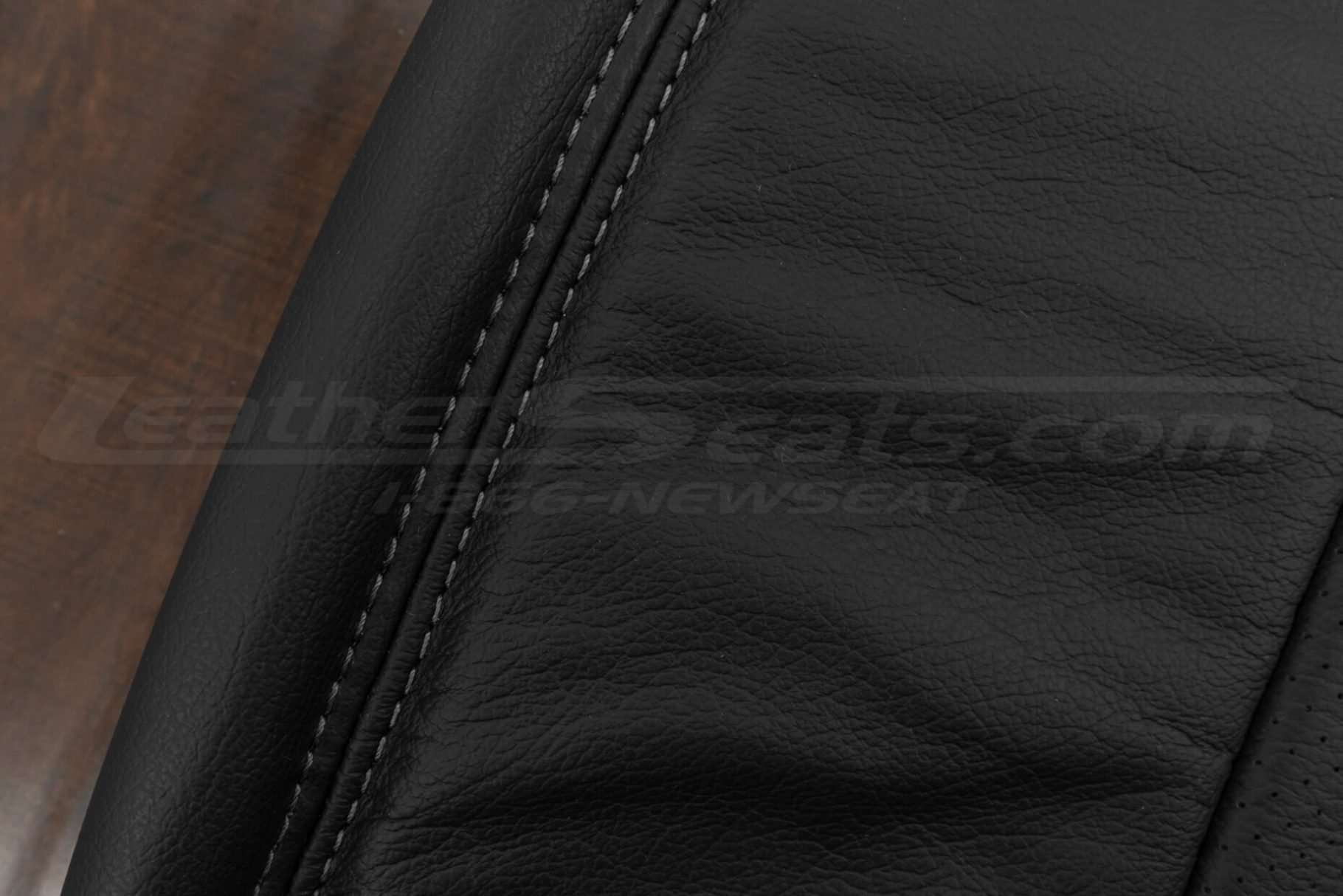 Charcoal double-stitching on black leather