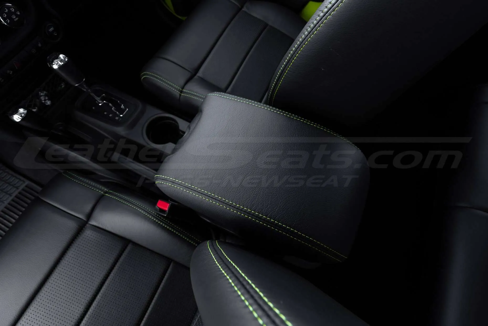 Top-down view of Black leather console lid with hyper green stitching