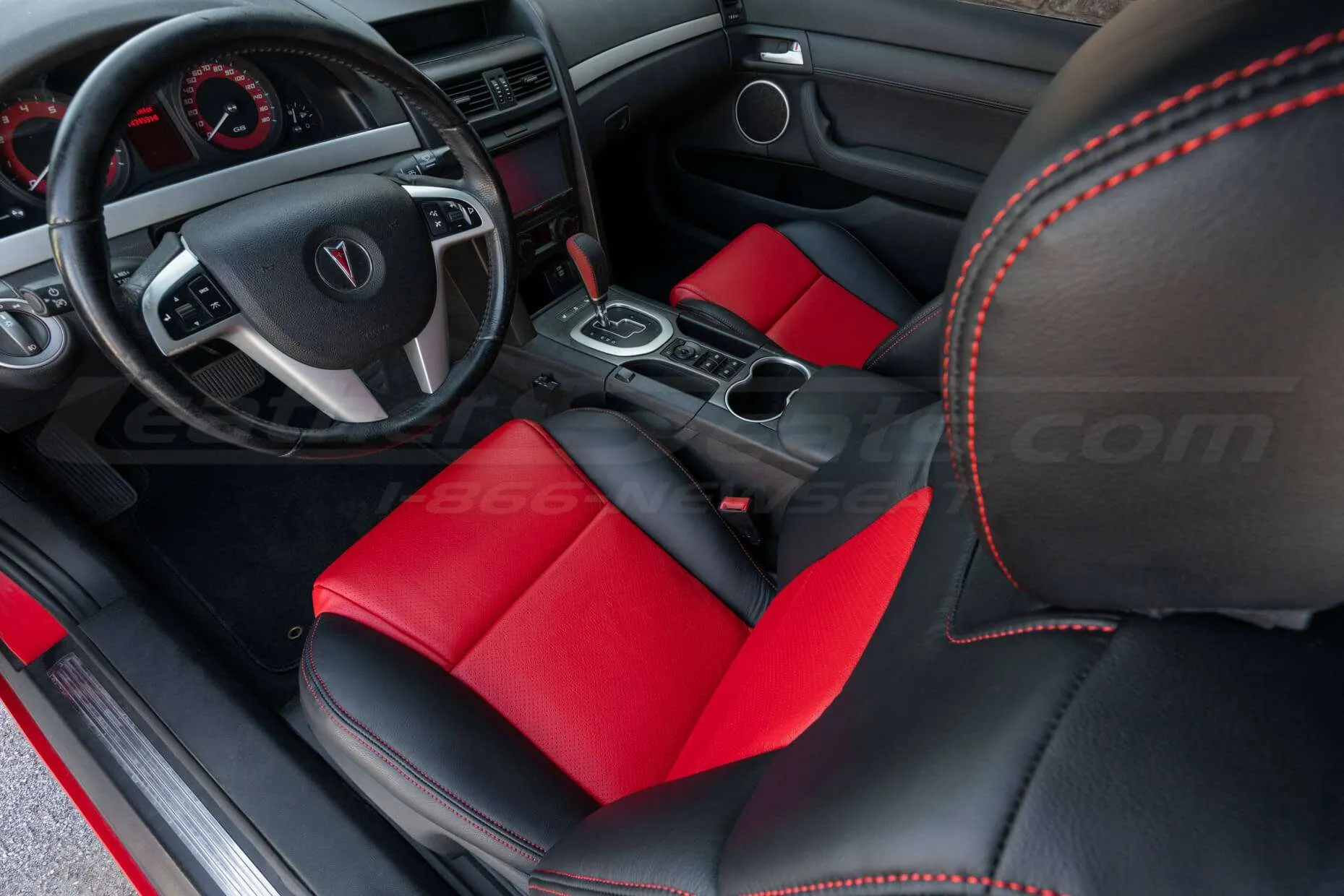 Top-down view of front driver seat with installed two-tone black and bright red upholstery
