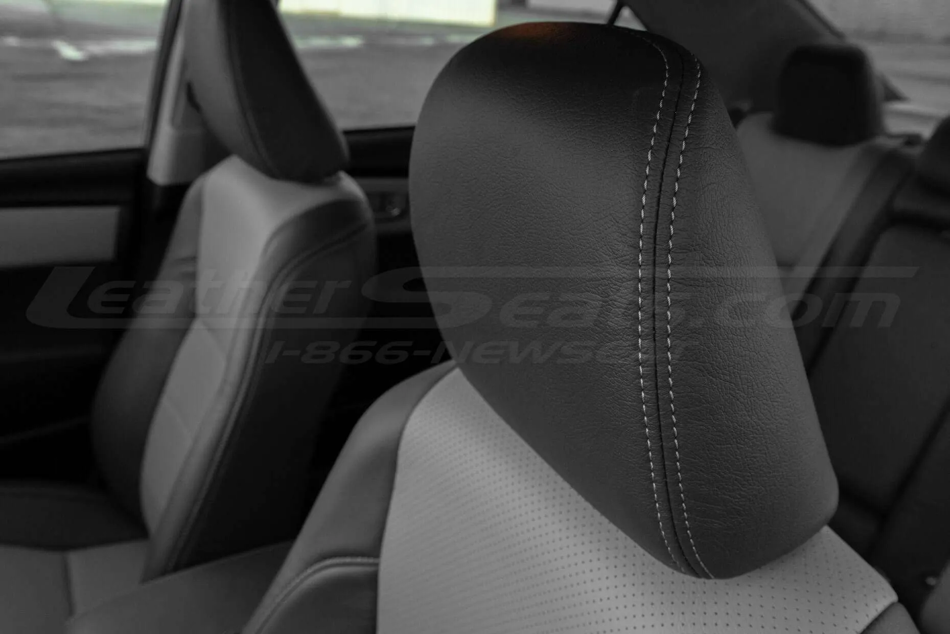 Leather headrest close-up in Dark Graphite with contrasting Ash thread