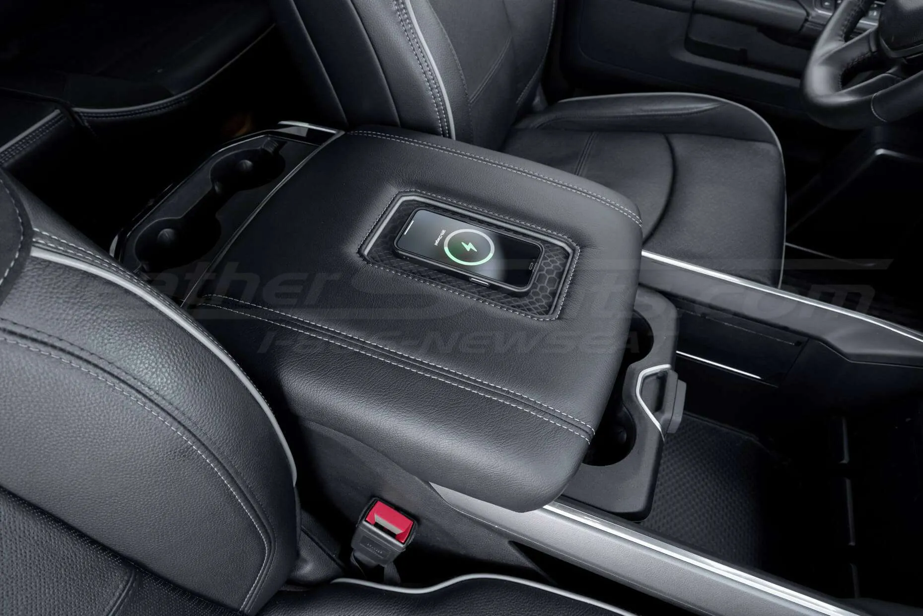 Black leather charging console charging iPhone in Dodge Ram