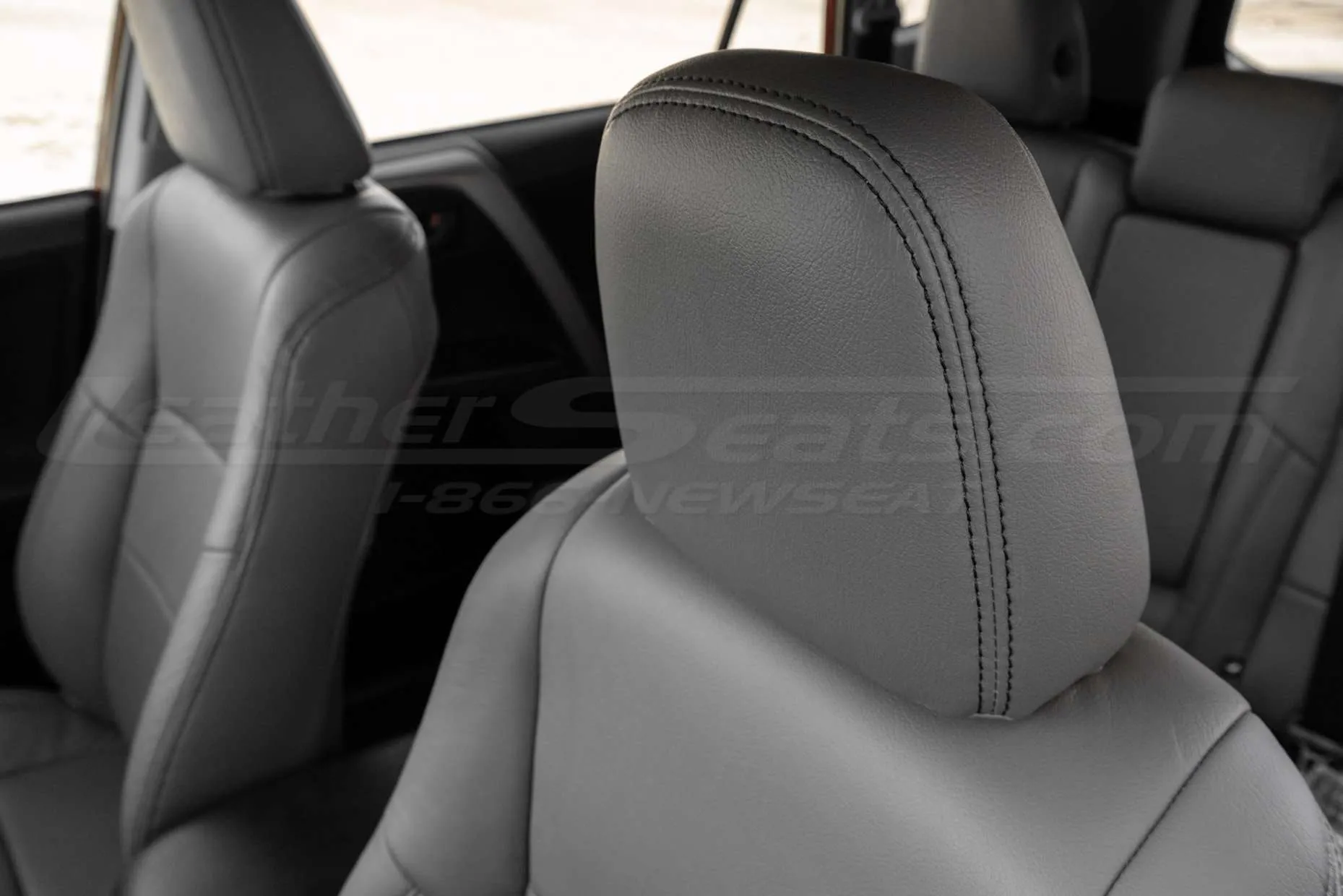 Leather headrest close-up with contrasting double-stitching in Black
