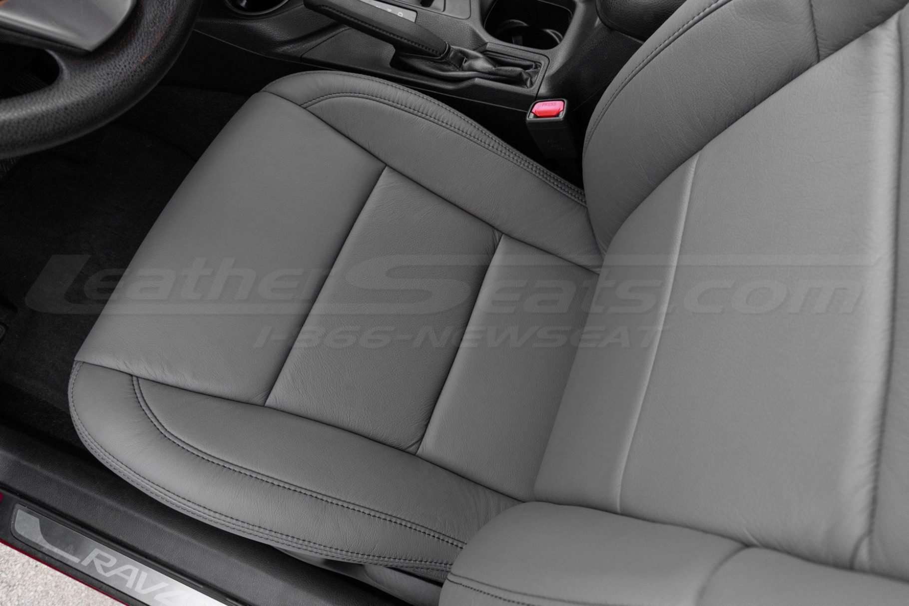 Top-down view of front driver seat in custom Light Grey leather upholstery