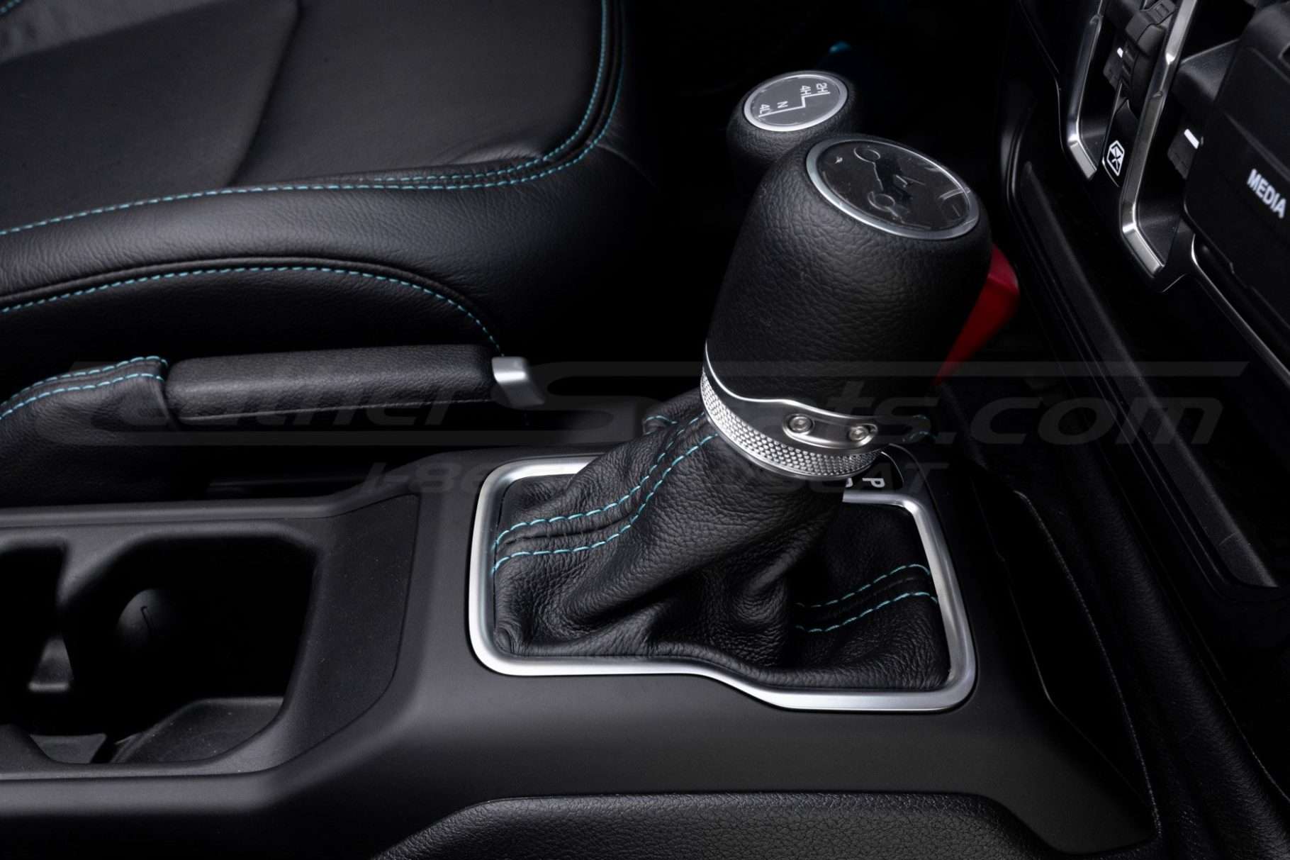 Side view of leather shifter with contrasting stitching