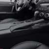 Black leather Mazda Miata hand brake upholstery with contrasting White stitching