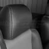 Graphite leather headrest close-up with contrasting smoke double-stitching