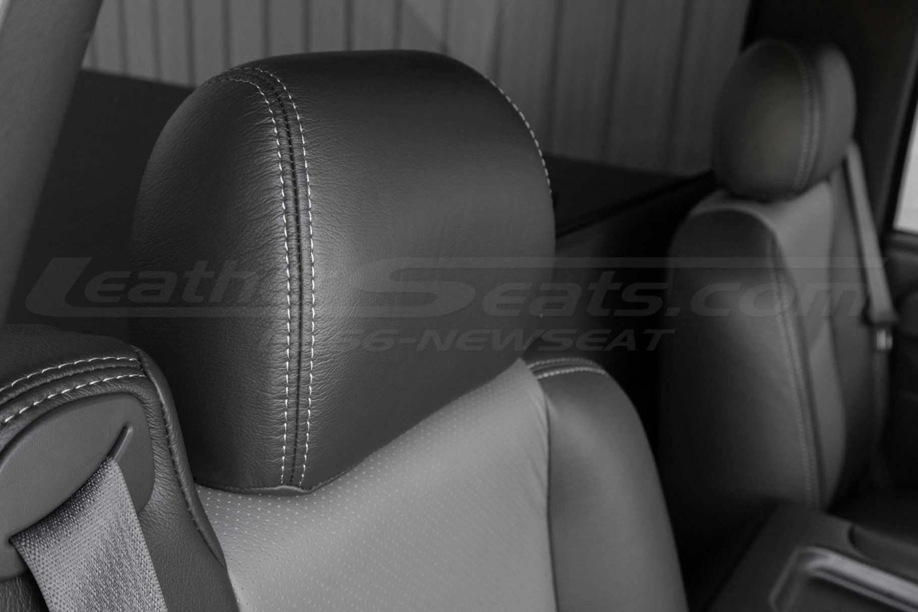 Graphite leather headrest close-up with contrasting smoke double-stitching