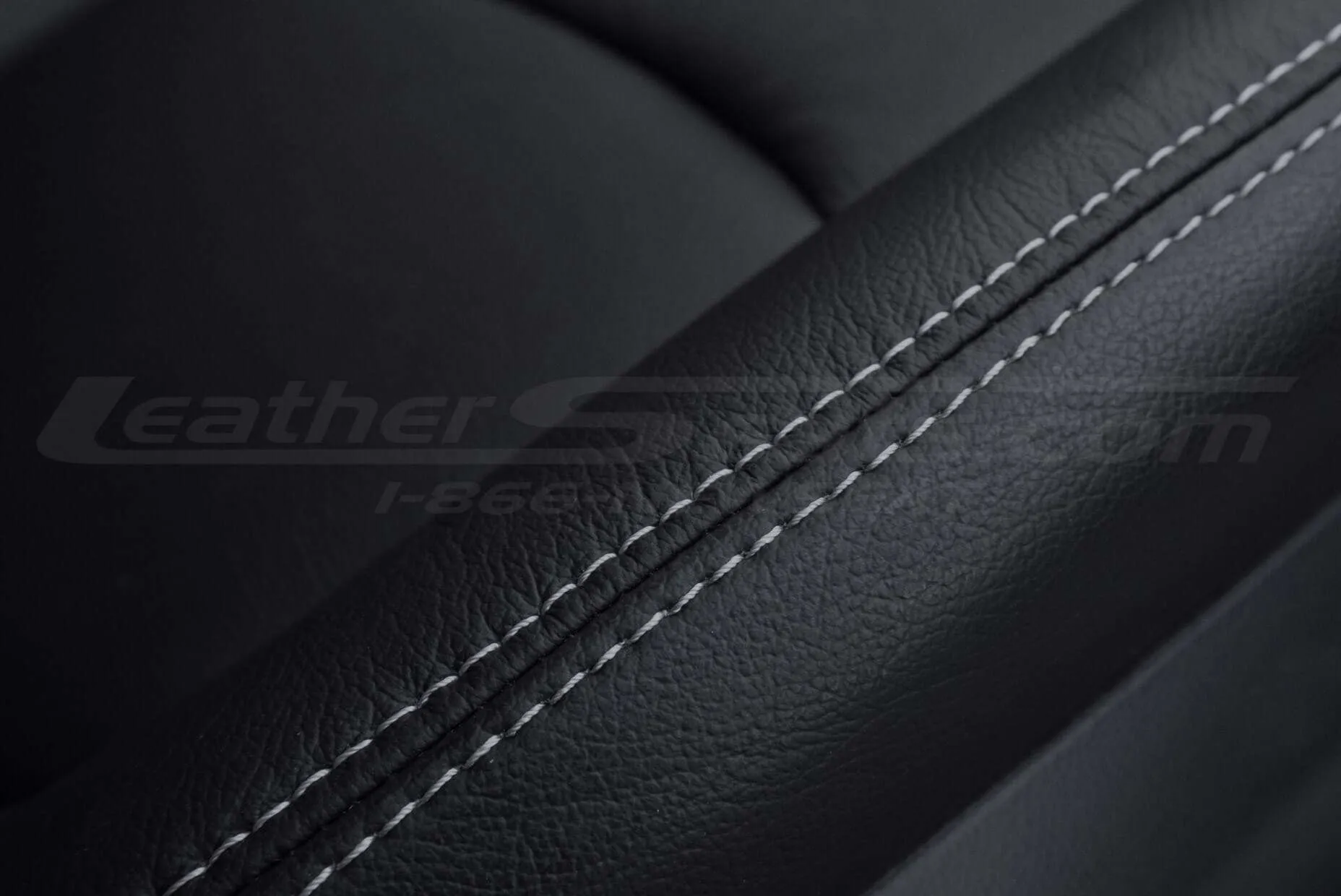 Close-up of Black leather with contrasting Dove Grey stitching