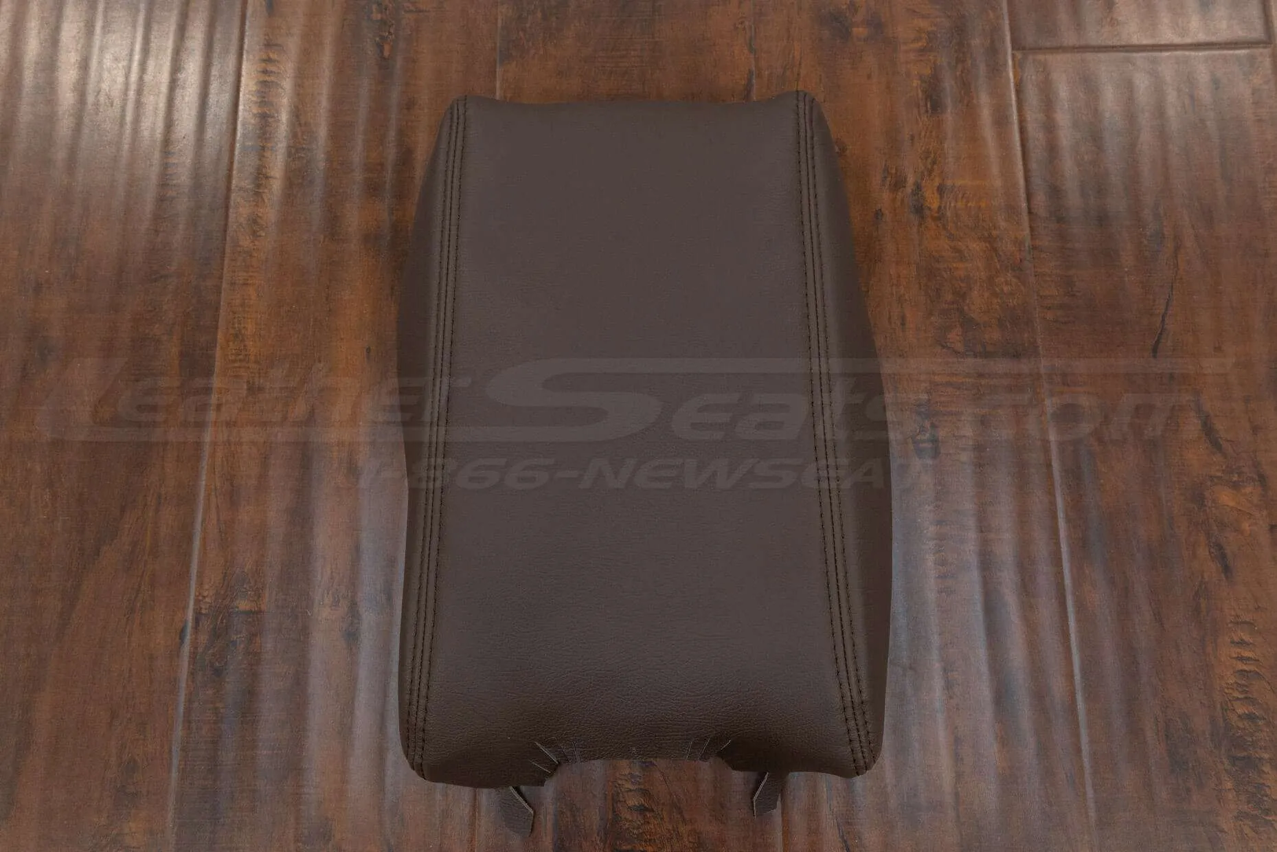 Top-down flat view of leather console lid cover with matching stitching