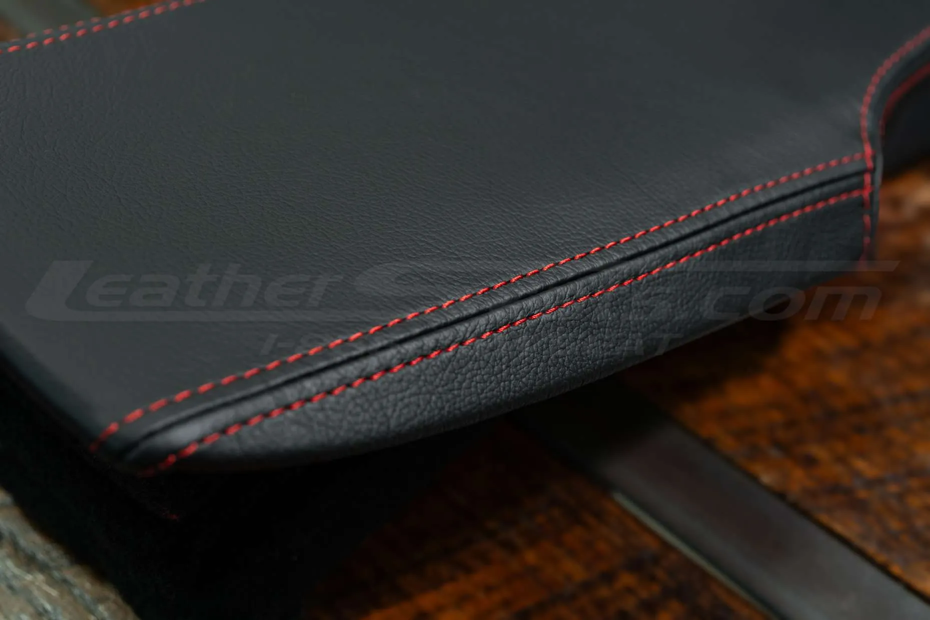 Contrasting double-stitching in Bright Red on Black leather close-up