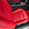Top-down view of front passenger Bright Red leather seat with perforated inserts