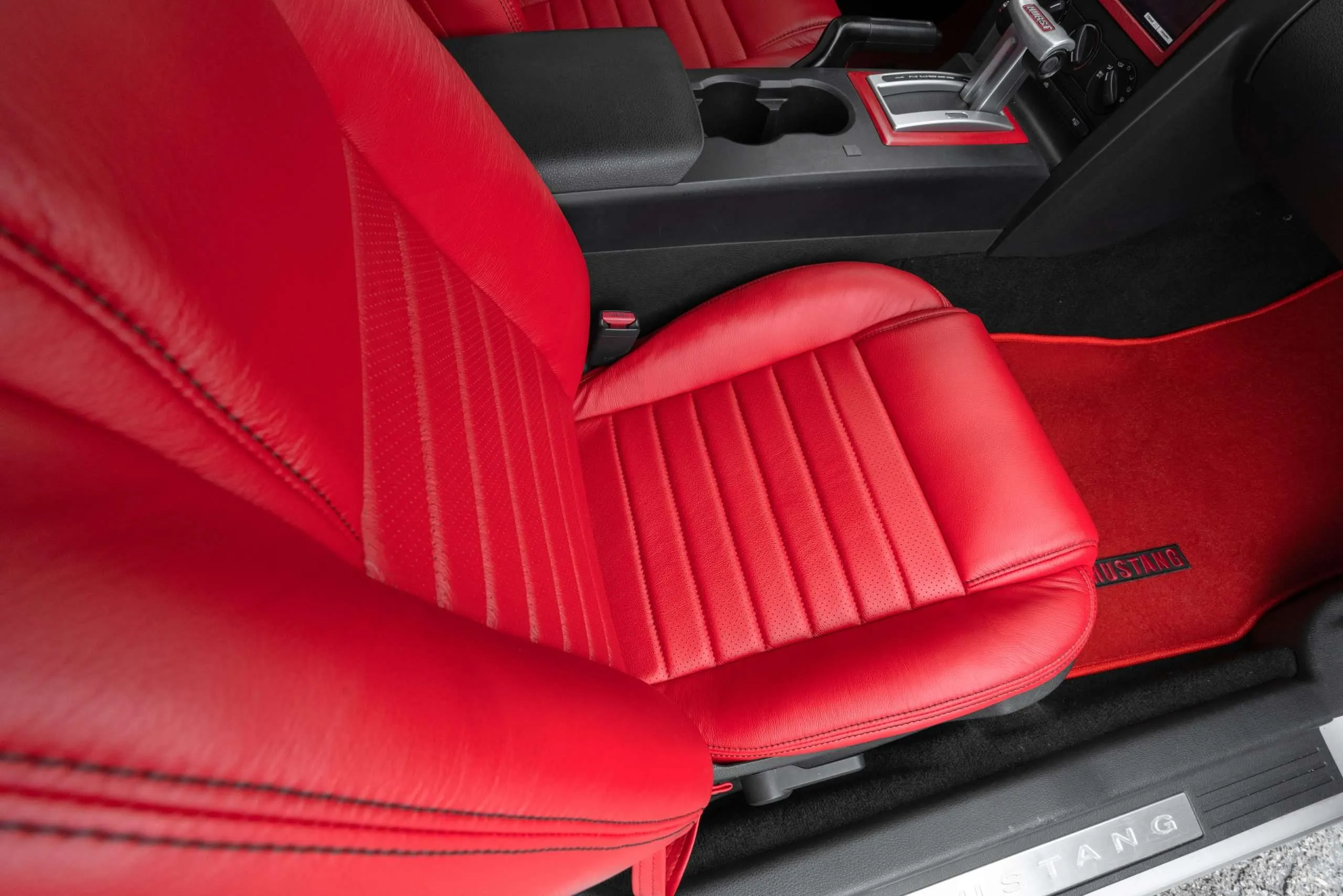 Top-down view of front passenger Bright Red leather seat with perforated inserts