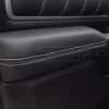 Black leather door armrest with ocntrasting white double-stitching