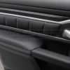 Top-down view of door armrest upholstery and quilted door panel
