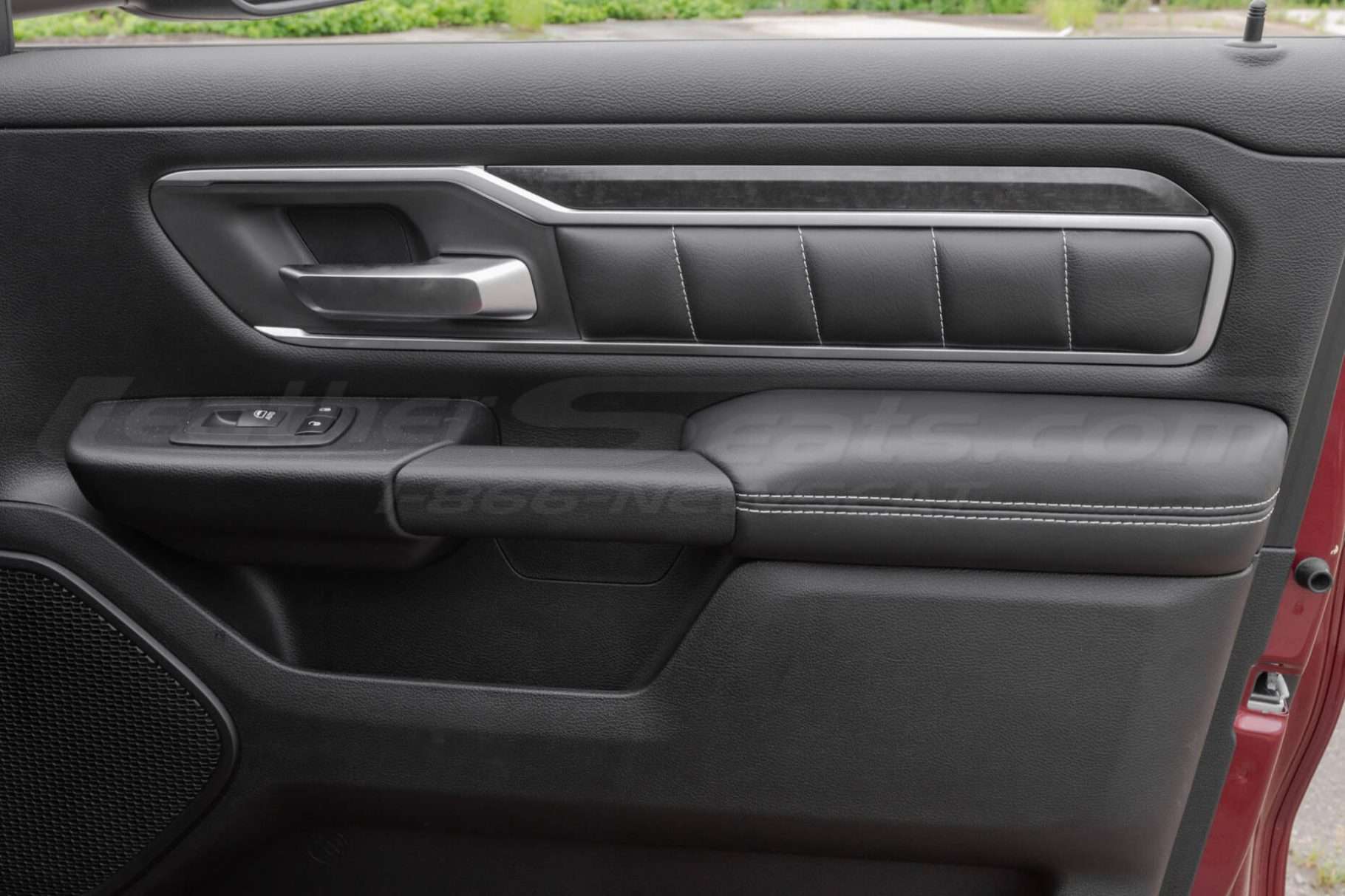 Passenger door with installed door panel inserts and armrests