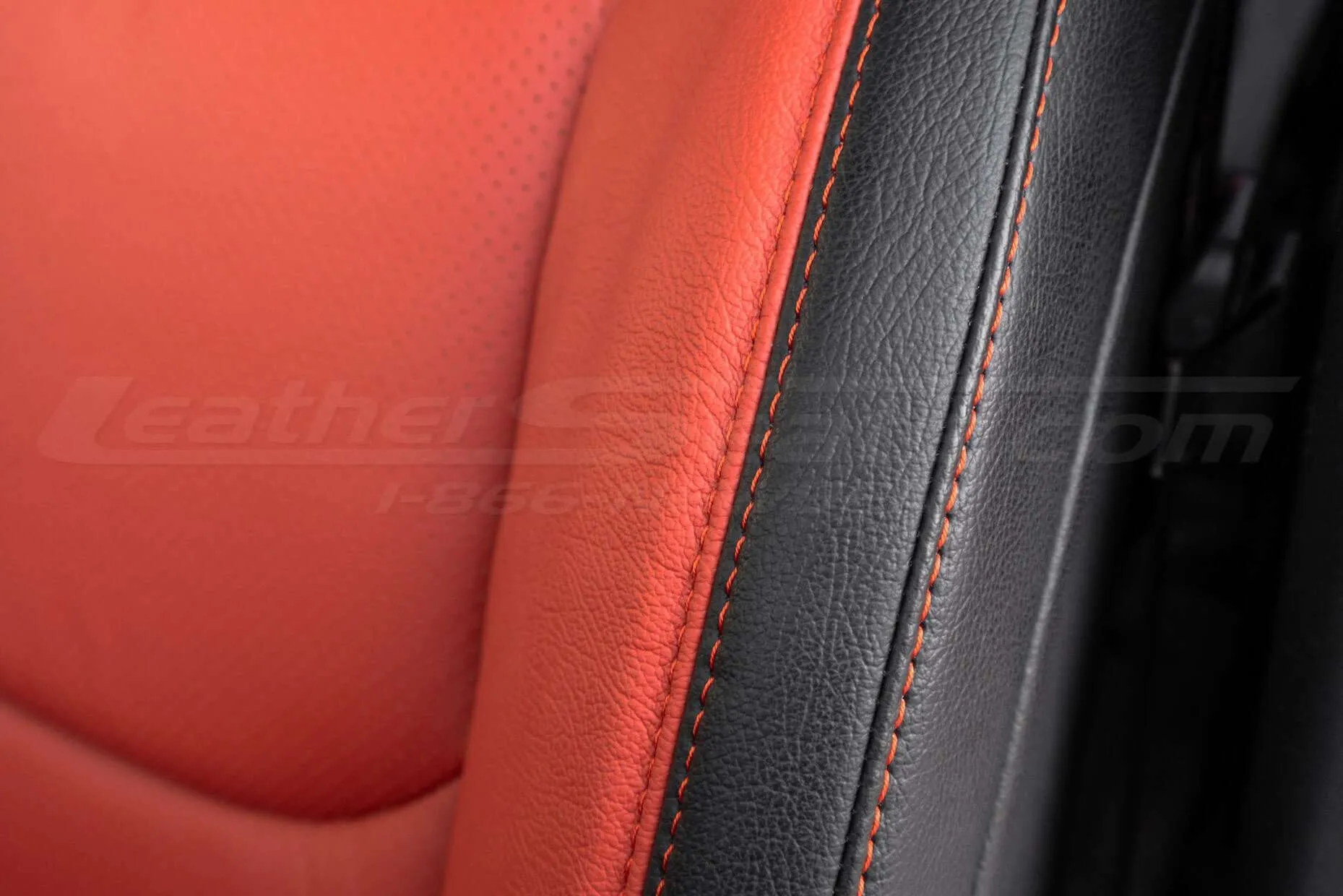 Contrasting double-stitching in Tangerine on Black leather - close-up