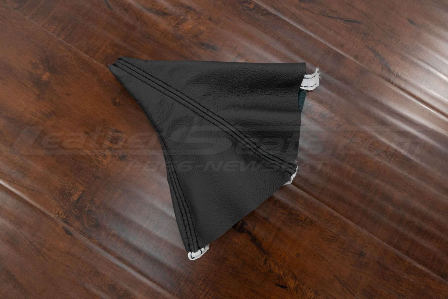 Flat lay side view of Dark Graphite leather shift boot upholstery for Mitsubishi 3000GT