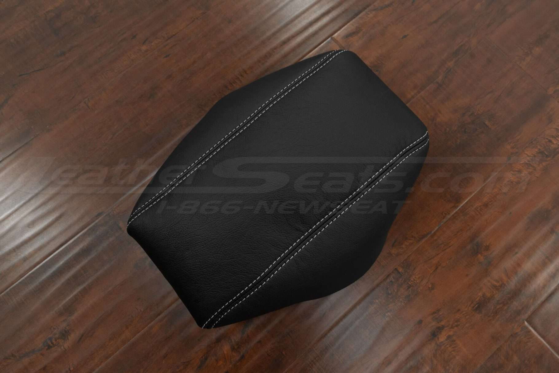 Top-down view of Black leather console lid cover with contrasting white stitching
