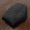 Black aftermarket leather console lid cover with contrasting white stitching