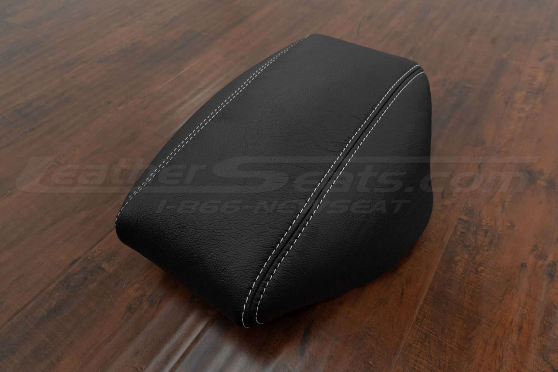 Black aftermarket leather console lid cover with contrasting white stitching