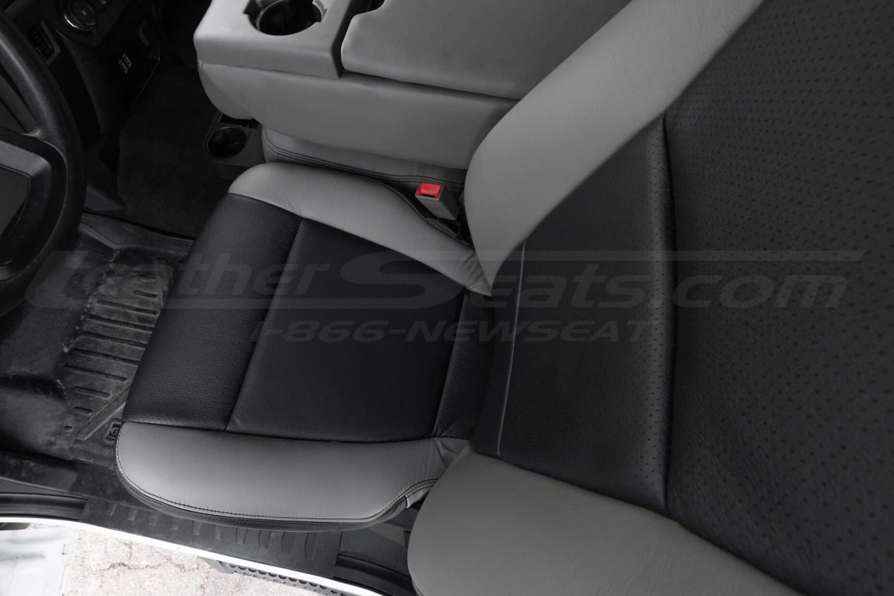 Top-down view of front driver seat showing leather texture and Black perforated body sections