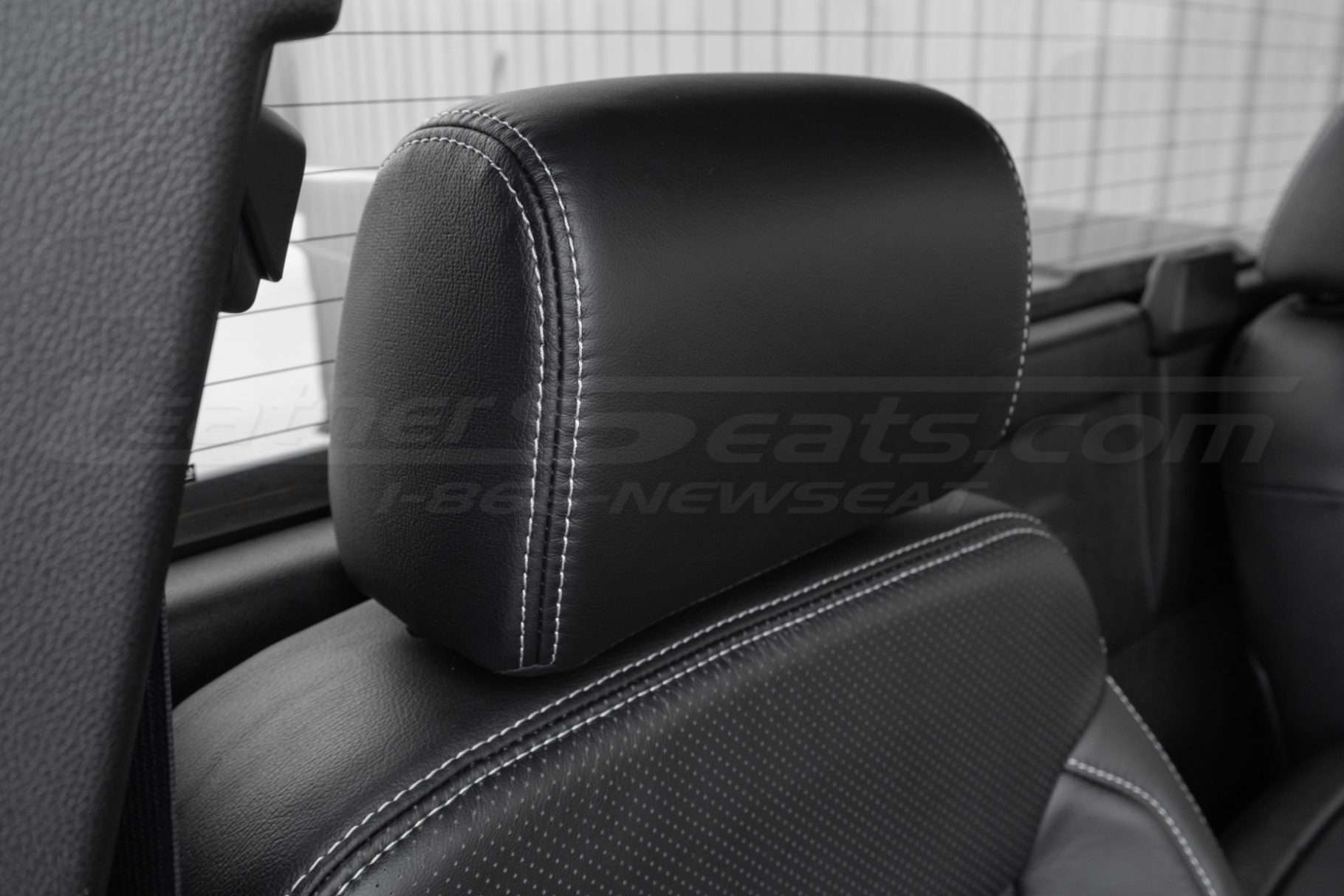 Leather headrest close-up with contrasting silver stitching