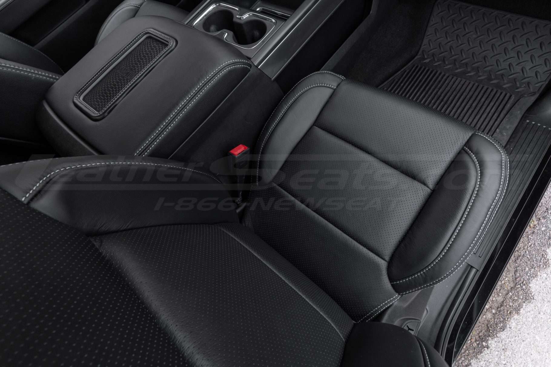 Top-down view of installed passenger seat with body perforation