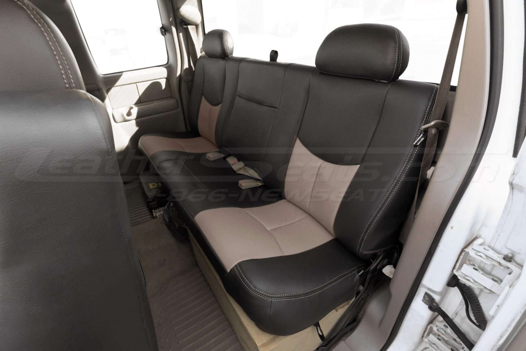 Driver side rear seat of Chevy Silverado with two-tone custom leather seats