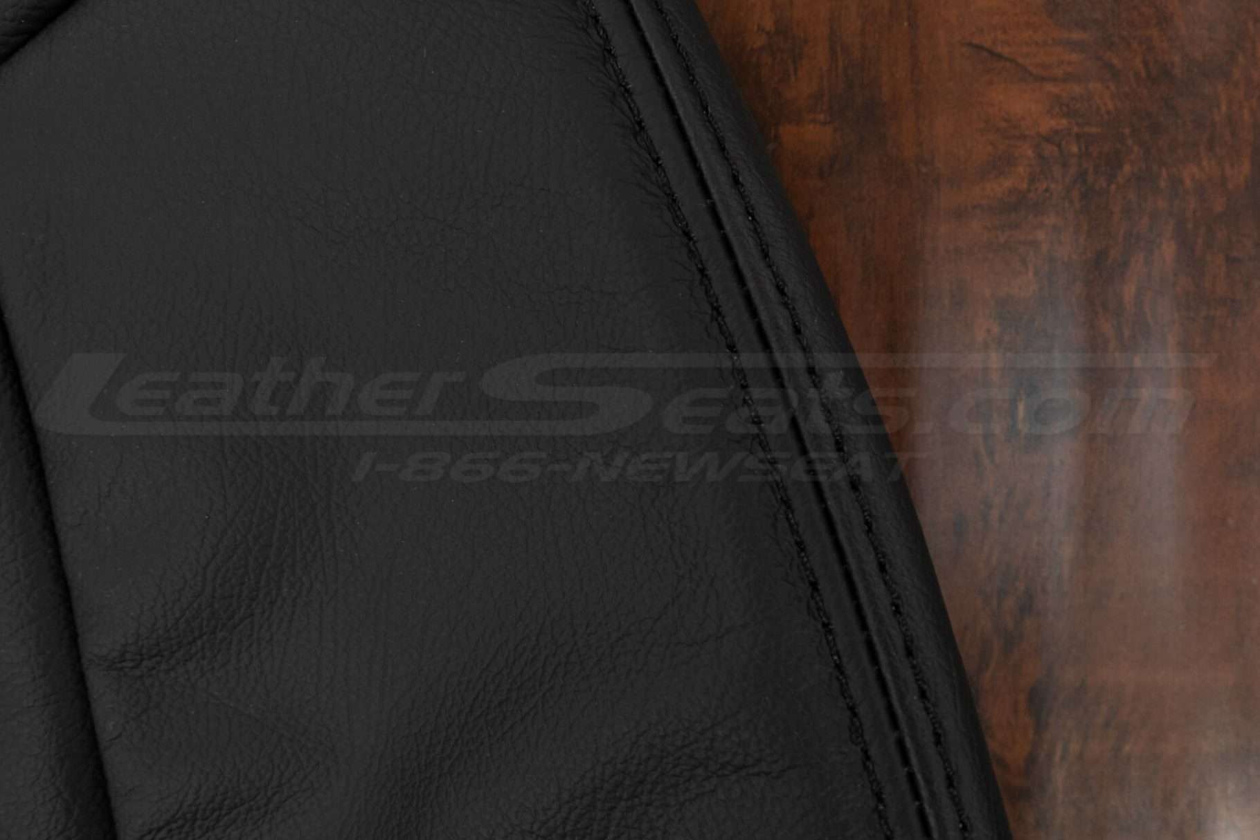 Matching black double-stitching on black leather