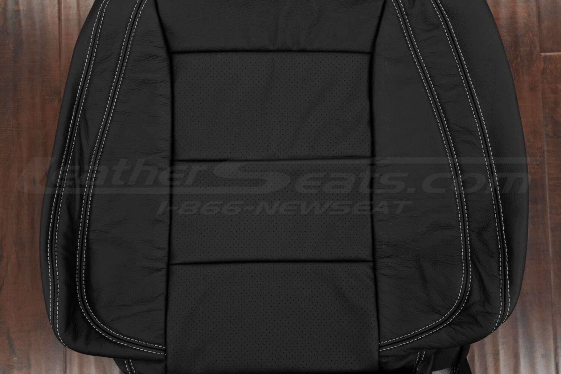 Black perforated insert section of leather backrest upholstery