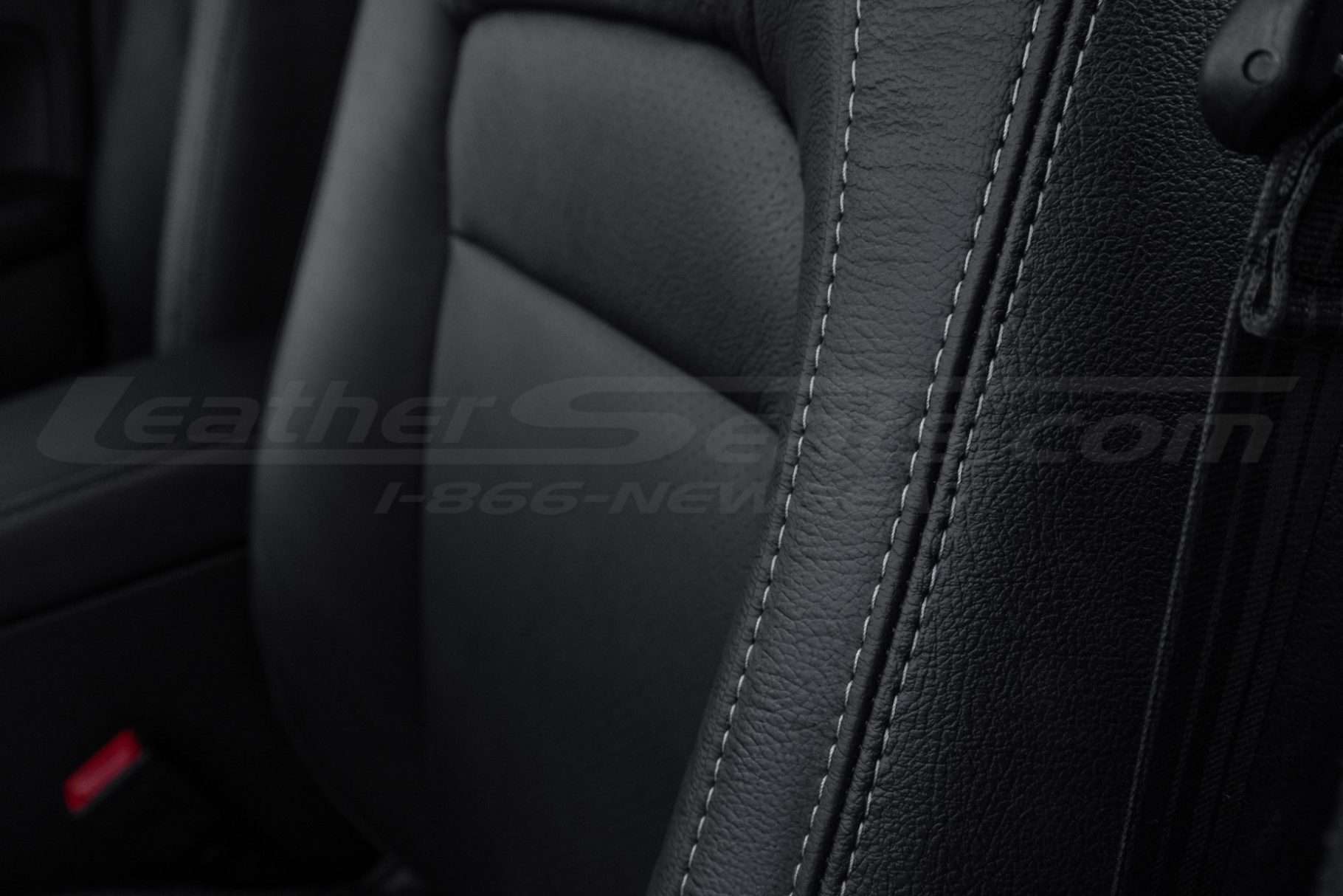 Contrasting stone double-stitching on Black leather bolster