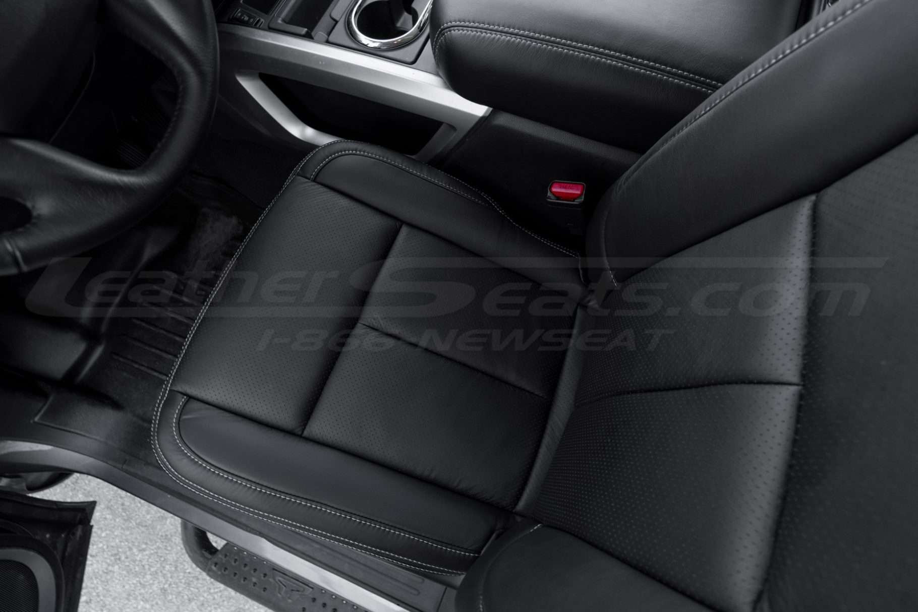 Top-down view of front driver seat with perforated body