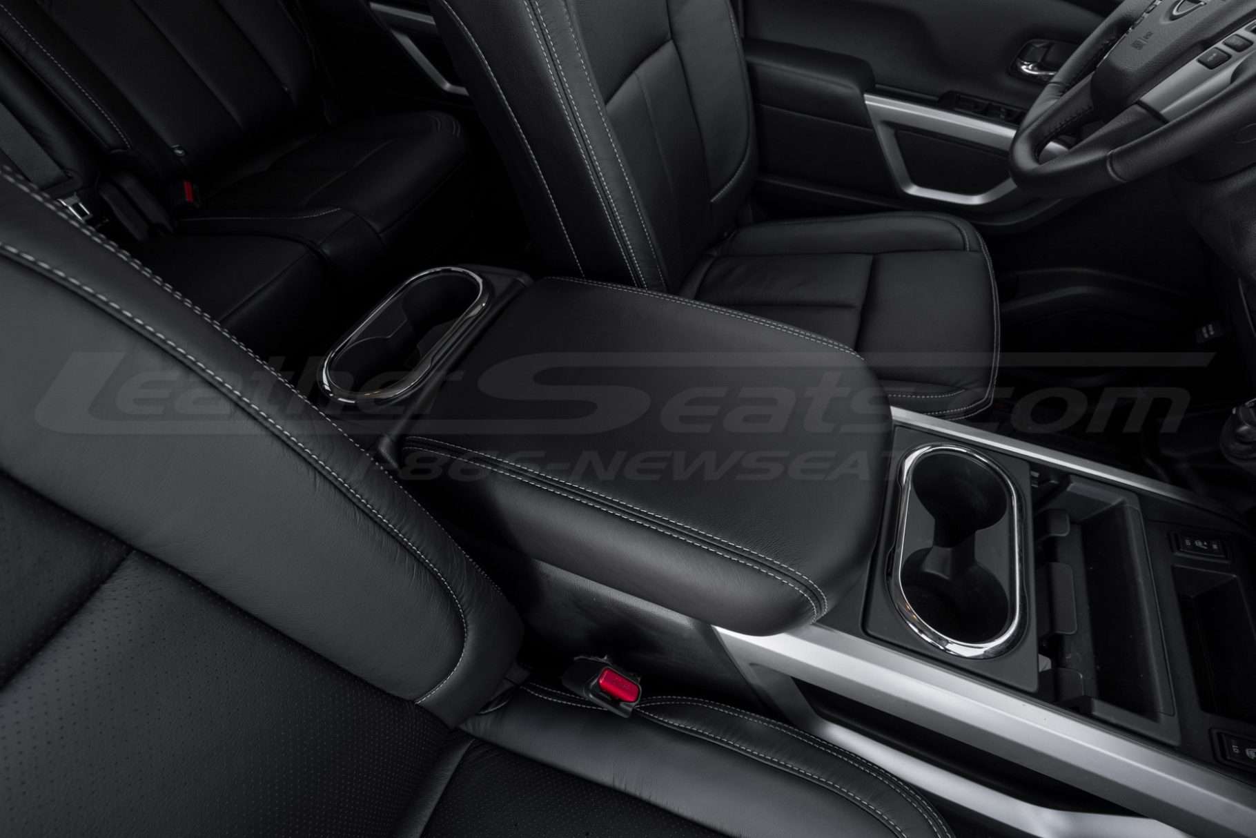 Top-down passenger view of black leather console lid cover for Nissan Titan Trucks
