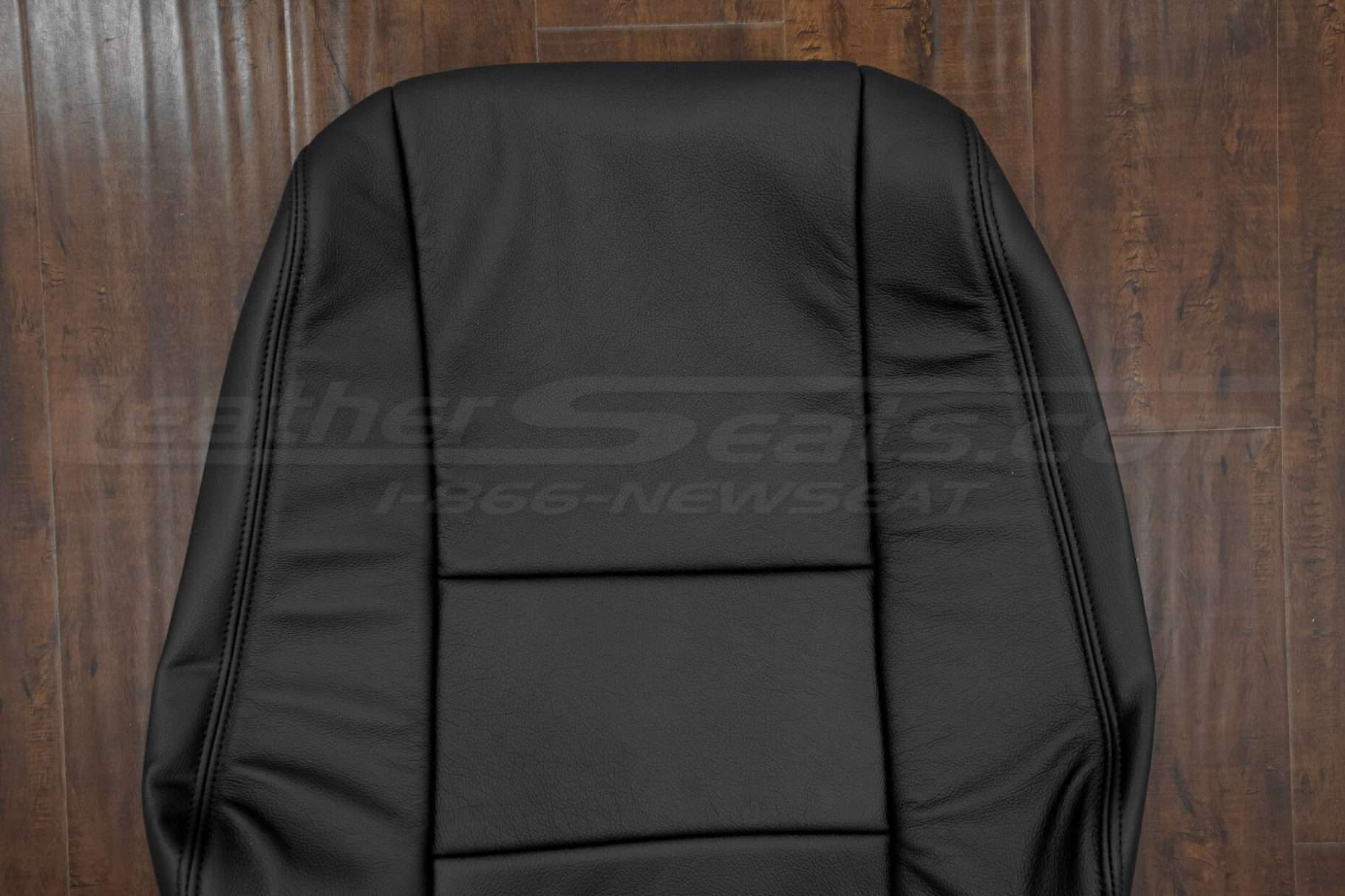 Upper section of black backrest upholstery
