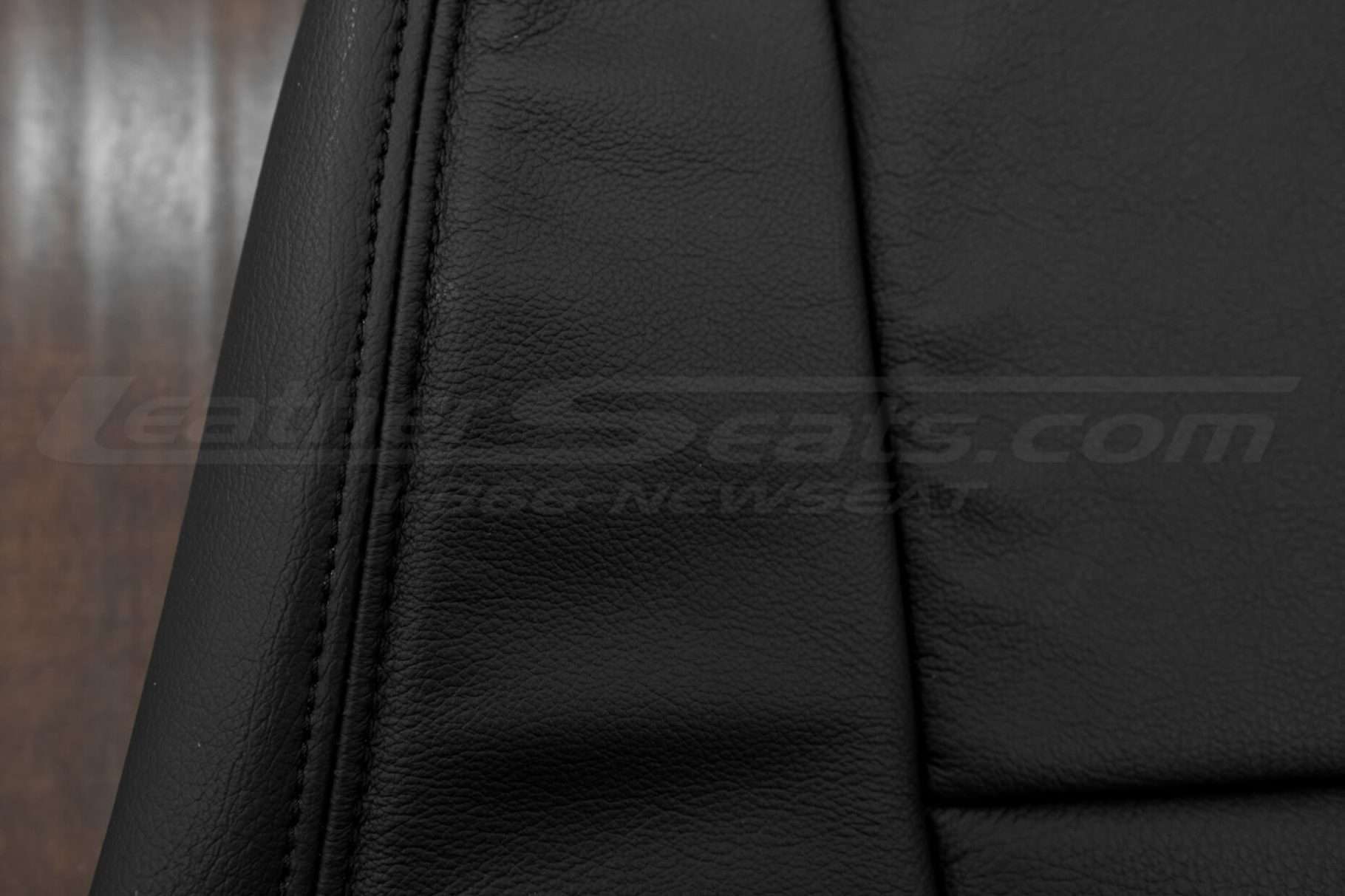 Black double-stitching on matching black leather
