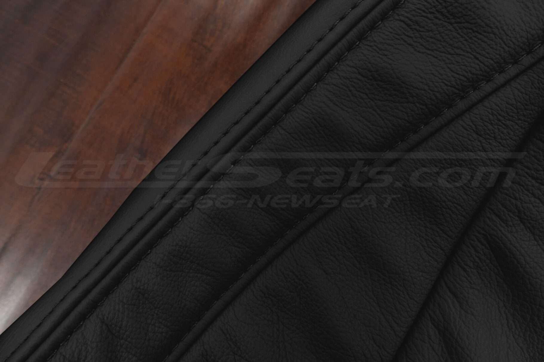 Black double-stitching on matching Black leather