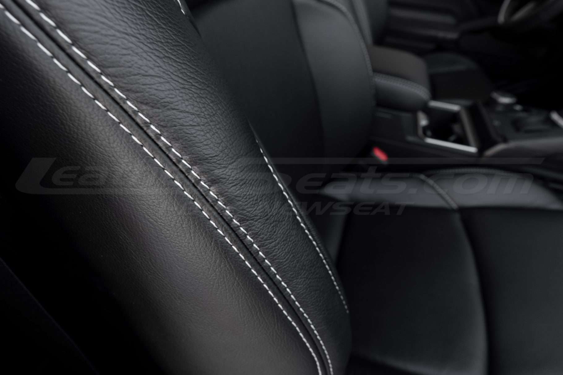 White stitching on black leather cover