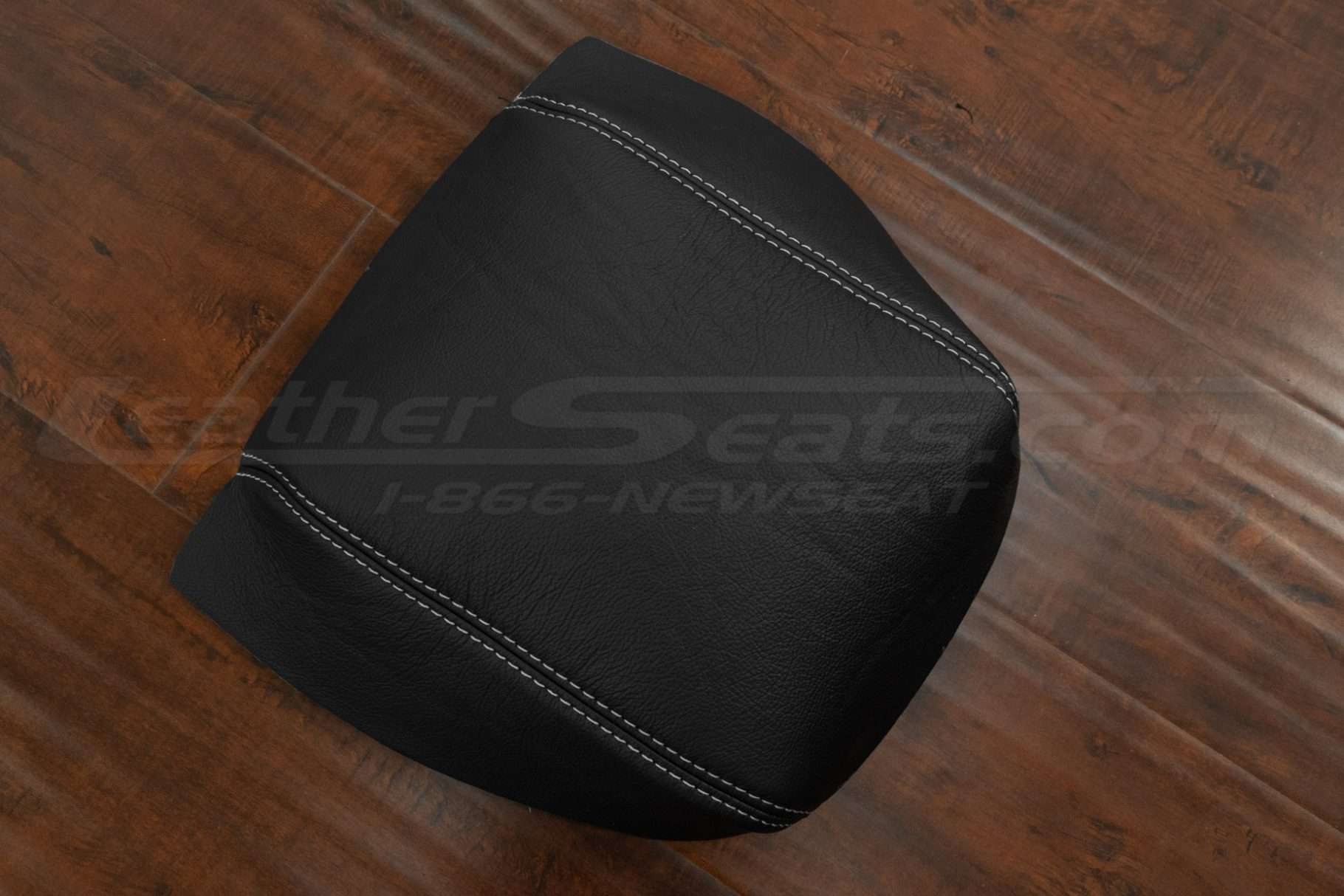 Top-Down side view of console lid cover in Black leather with dove grey stitching