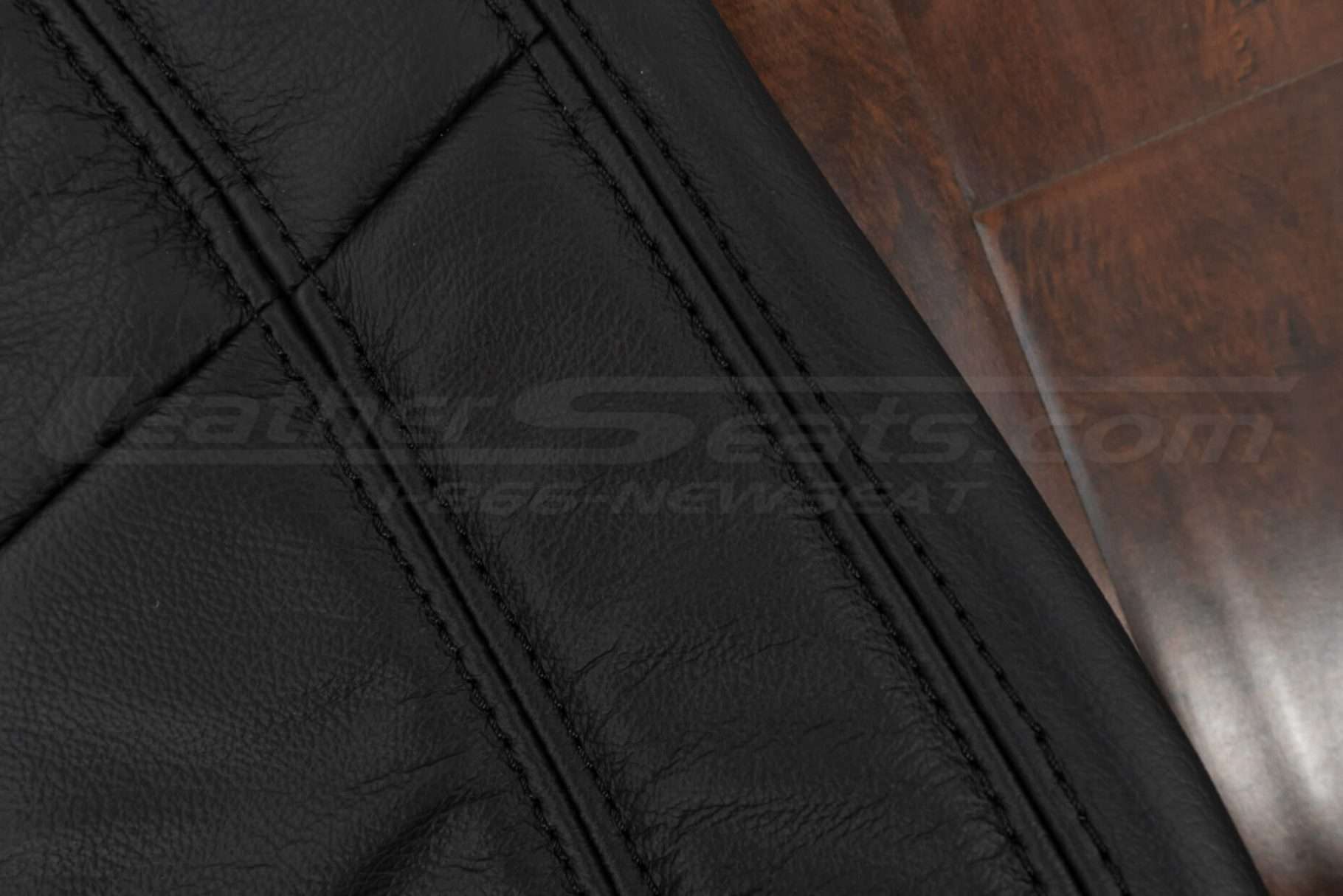 Black stitching on black leather backrest