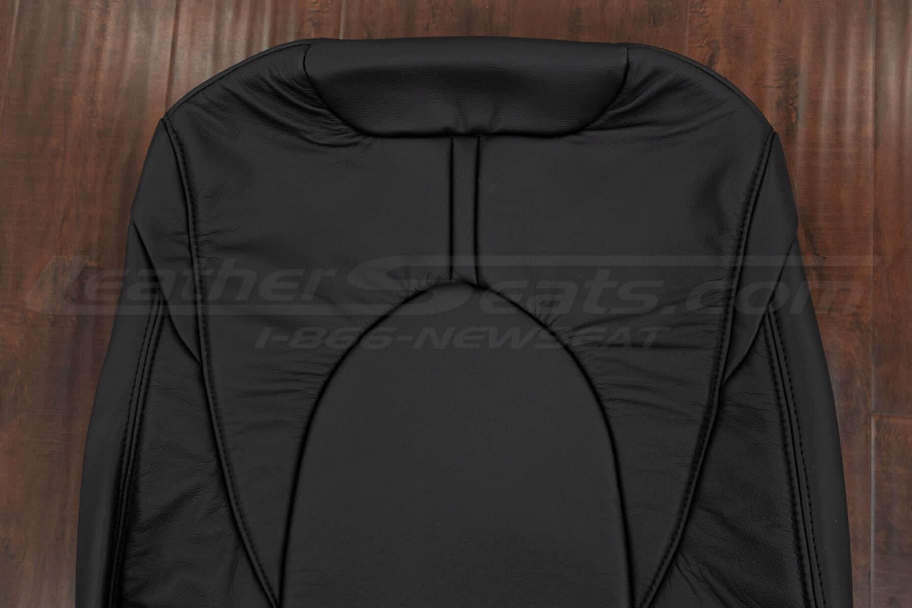 Upper section of black backrest upholstery