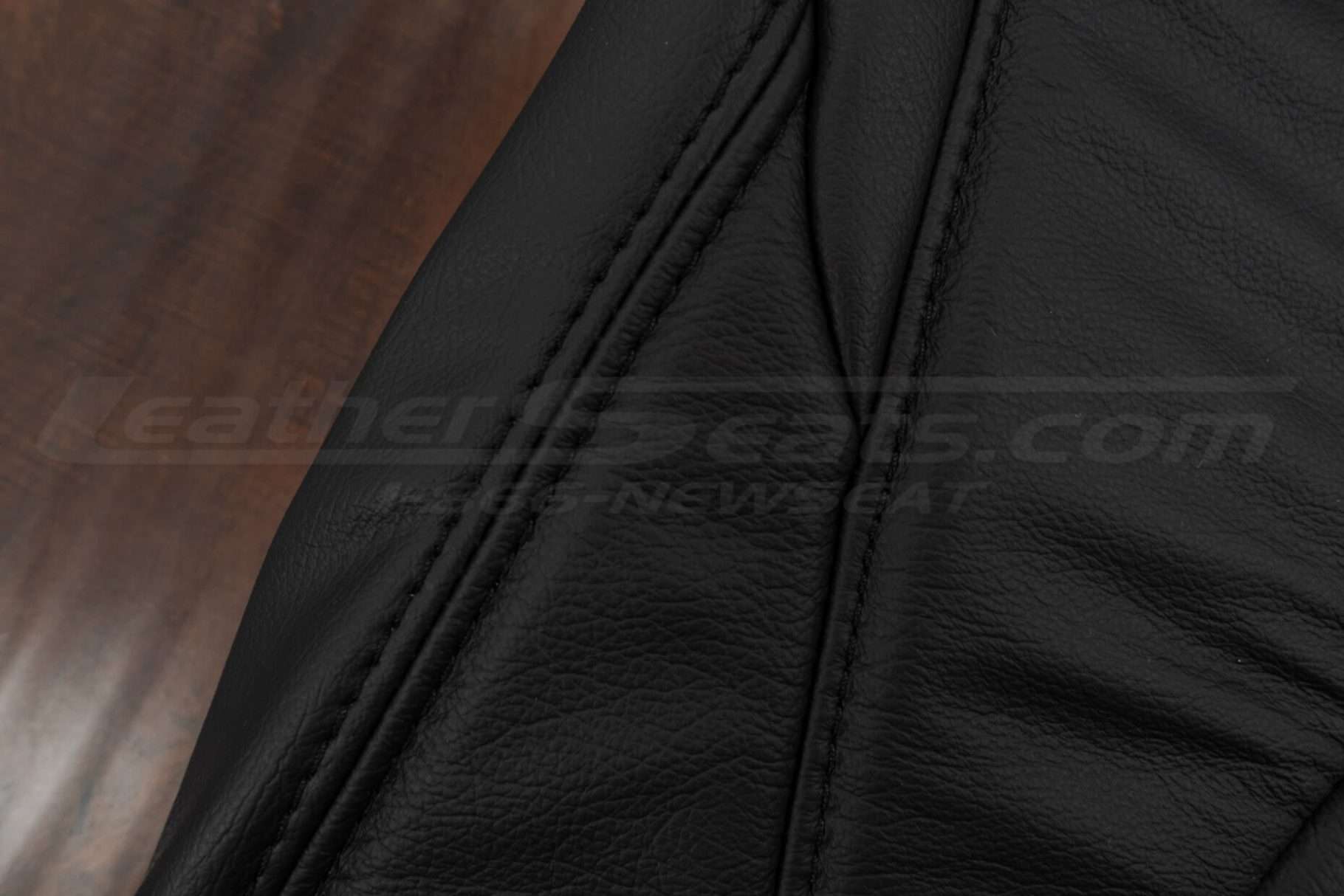 Black double-stitching on black leather