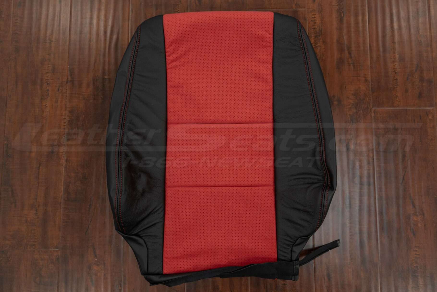 Black leather backrest with red perforated suded body sections