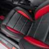 Top down view of front driver leather seat with perforated inserts