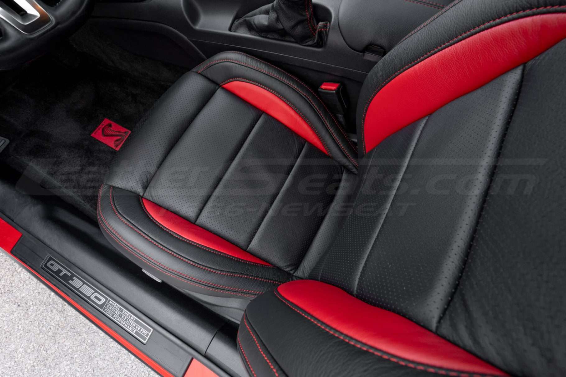 Top down view of front driver leather seat with perforated inserts